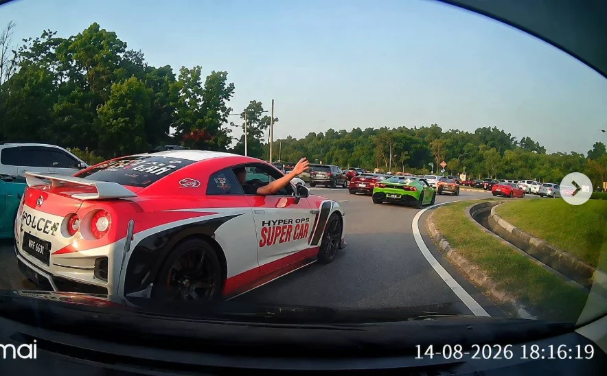 Luxury car convoy passing through traffic at Bulatan Lebuh Kota Iskandar in Johor.